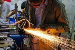 Worker welding metal